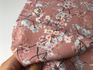 Fastvævet viscose - søde kirsebærblomster på rosa bund